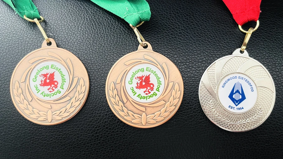 Medals bearing the Geelong and Ringwood Eisteddfod emblems