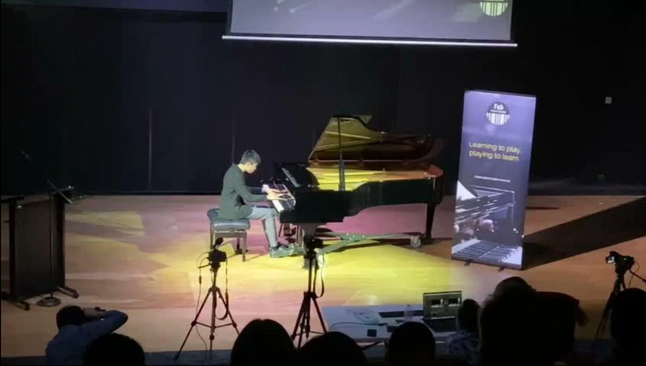 Isaac performing at a grand piano on stage